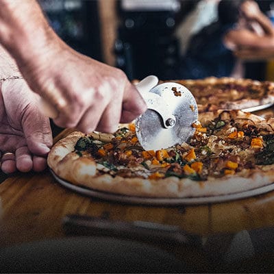 Pizza being cut