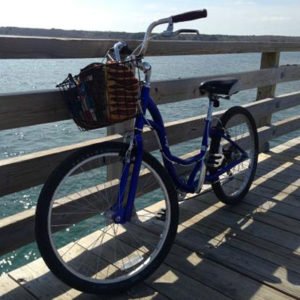 Bike on a bridge with water in the background