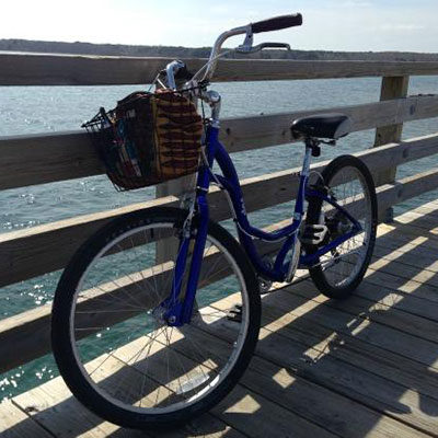 Bike on a bridge with water in the background