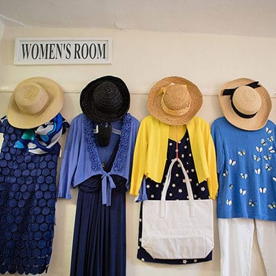 Women's clothing and hats hanging at the hospital thrift shop