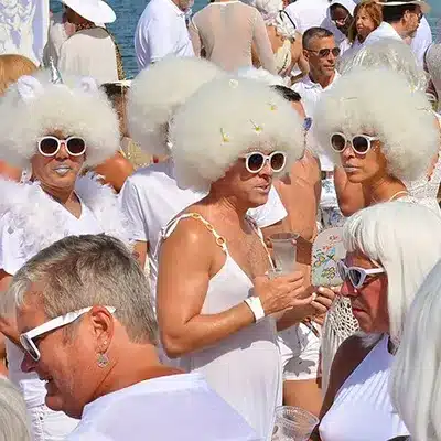whitePartyPtownFeatured People dressed in all white partying on the beach