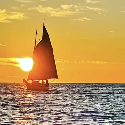 Boat on the water with sunset backdrop